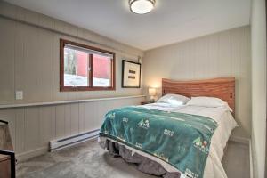a bedroom with a bed with a green blanket at Inviting Vermont Cabin On Mount Ascutney! in Brownsville