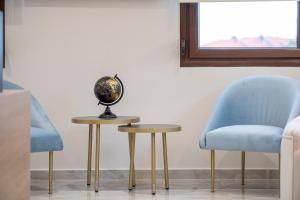 a globe sitting on a table next to two chairs at VagAthan - Lux Holidays in Afitos