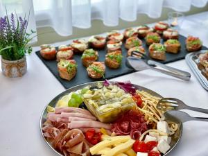 a plate of food on a table with appetizers at Hotel Modena in Bratislava