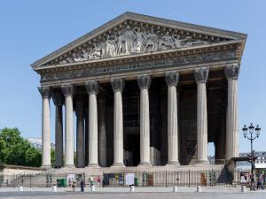 a large building with columns in front at Luxury 2 Bedroom - Louvre & Champs Elysees in Paris