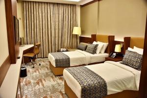 Postel nebo postele na pokoji v ubytování فندق رويال فيستا Royal Vista Hotel