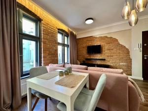 a living room with a couch and a table at PasteLove Okna in Toruń