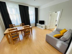 a living room with a table and a couch at Brauhaus und Pension Babben in Lübbenau