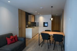 a kitchen and living room with a table and chairs at Apartments Emilia in Ortisei