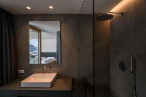 a bathroom with a sink and a shower at Apartments Emilia in Ortisei