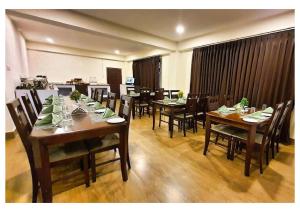a dining room with wooden tables and chairs at Stay villa Retreat in Pelling