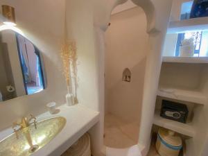 a bathroom with a sink and a mirror at Riad Dar Marrakcha in Marrakesh +44 photos
