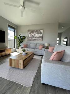 a living room with two couches and a tv at Modern home away from home in Mansfield