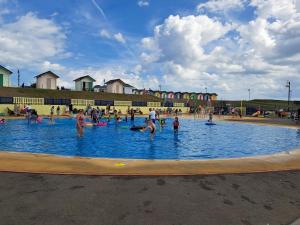 a group of people playing in a swimming pool at Beachside caravan in Mablethorpe