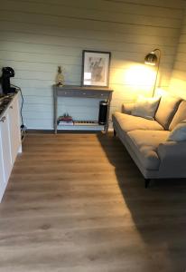 a living room with a couch and a table at Highland cabin - relaxing hot tub in Inverness