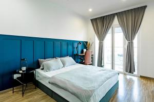 a blue bedroom with a bed with a blue wall at SETAPAK CENTRAL KL-zeta suite by ALOHA in Kuala Lumpur