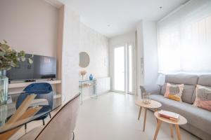 a living room with a couch and a table at MyHouseSpain - Nuevo apartamento junto al Bernabéu in Madrid