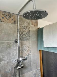 a bathroom with a shower with a shower head at Quinta da Boa Sorte in Estói