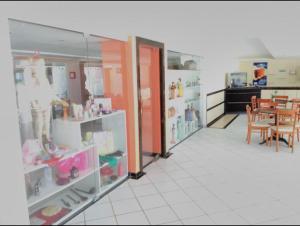 a store with a dining room and a table in a room at Apart Hotel Marinas Vista para o Mar Praia dos Carneiros in Tamandaré
