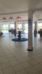 a lobby with a tile floor with umbrellas at Apart Hotel Marinas Vista para o Mar Praia dos Carneiros in Tamandaré