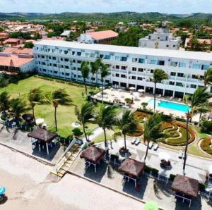 an aerial view of a resort with palm trees at Apart Hotel Marinas Vista para o Mar Praia dos Carneiros in Tamandaré