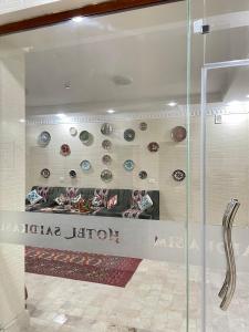 a display window of a store with plates on the wall at Hotel Saidkasim with a Terrace in Bukhara