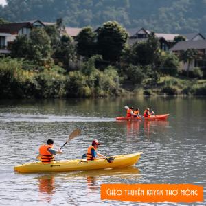 a group of people in kayaks on a river at Thang Mây Village Rersort in Ba Vì