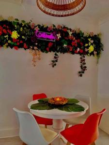 a dining room with a table and chairs and flowers at The Light House in Seaham