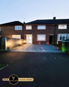 a large brick building with a large parking lot at Luxury, 4 Bedroom House, FREE Parking, Borehamwood in Borehamwood