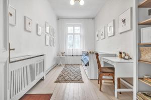 a white home office with a desk and a chair at Romantická Chalupa Louka 