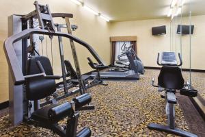 a gym with several tread machines and a cell phone at La Quinta Inn and Suites by Wyndham - Schertz in Schertz