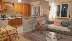 a living room with a couch and a table at Appartamento ' NINFEA' LT in Genova