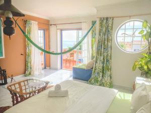 a bedroom with a bed and a large window at Ericeira Soulsurfers Guesthouse in Ericeira