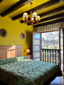 a bedroom with a bed and a large window at Apartamentos Turisticos Paseo de la Alameda in Villaviciosa