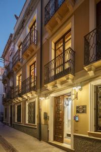 a building with balconies on a street at night at Le Meraviglie di Alice in Cagliari