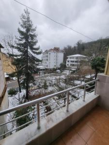 a balcony with a view of a city in the snow at Thermal Orkide Pansiyon in Yalova