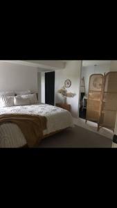 a bedroom with a bed and a clock on the wall at Palm Springs Vibe - Gorgeous Large Home, Superb Location in Noosa Heads