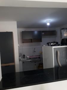 a small kitchen with a sink and a refrigerator at Ed. Oliveiro Lucena in João Pessoa