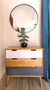 a dresser with a mirror on top of it at Le Bel Air - Central avec Climatisation & Parking in Gréoux-les-Bains