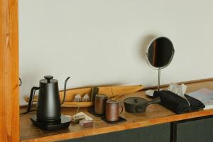 a desk with a mirror and a coffee maker on it at DENIM HOSTEL float in Kurashiki