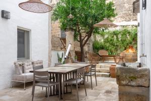 a patio with a wooden table and chairs at Casa a Corte, Nardò in Nardò