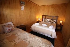 Giường trong phòng chung tại Hospedaje Icalma