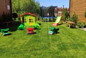 a group of toys on the grass in a yard at Słoneczny Przystanek in Jarosławiec