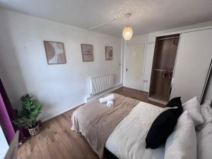 a bedroom with a bed and a potted plant at Manchester City Centre 2 Bedroom Apartment in Manchester