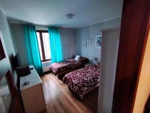 a hotel room with two beds and a window at SAS Apartamenty New Park in Szczecin