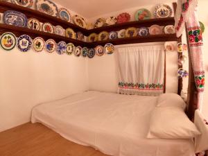 a bedroom with plates on the wall and a bed at LoView Avlona 