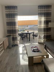 a living room with a table and a dining room at Cozy apartment in Los Cristianos in El Guincho