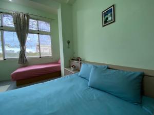 Postel nebo postele na pokoji v ubytování 豐綠民宿 Yilan Fenglu Homestay