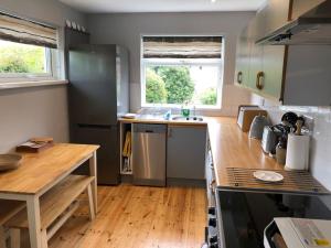 a kitchen with a table and a counter top at Penzance- West Cornwall seaside getaway in Penzance