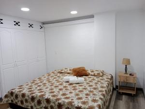 a bedroom with a bed with two towels on it at Medellin apartamento en laureles in Medellín