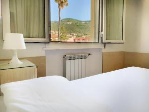 A bed or beds in a room at Ligure Residence