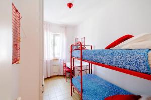 a room with two bunk beds and a window at Appartamento a 20mt dal mare con piscina condominiale in Marcelli