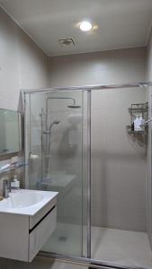 a bathroom with a shower and a sink at Tien Chon Xiao Lin Homestay in Jiaoxi