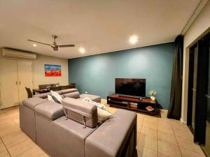 a living room with two couches and a flat screen tv at Modern 2 Bed Apartment - Oaks Resort, Cable Beach in Cable Beach