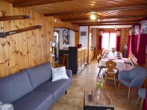 a living room with a blue couch and a table at Chant du Torrent: 12 pers. idéal pour les familles in Nendaz
